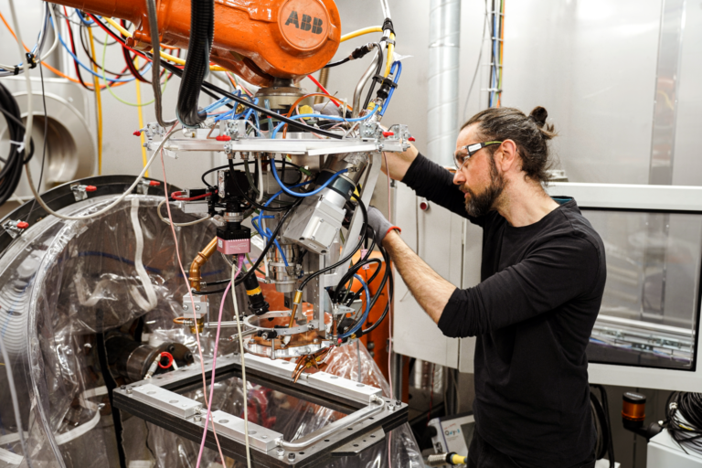 Almir-Heralic-medgrundare-Procada-kalibrerar-ett-3D-skrivarverktyg-som-sitter-pa-en-industrirobot.-Foto-Jimmy-Delwer